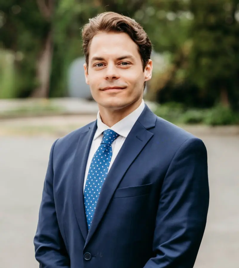Man in navy suit outdoors portrait